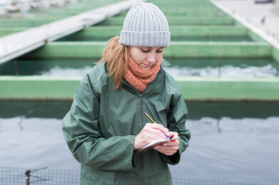 Portrait,Of,Woman,Working,On,Fish,Farm,,Making,Notes,In